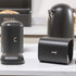 Matte black metal kettle and matching tea caddy with rose gold handle on kitchen counter