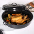 Black enamel roasting set with lids, shown with roast and roasted vegetables on kitchen counter