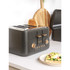 Four-slot copper and black toaster with controls, angled side view