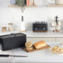 Black bread bin with handle on natural wood base, product listing image