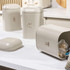 Set of three beige kitchen canisters with metallic letters for tea, coffee, and sugar