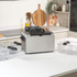 Silver deep fat fryer with black handle, showing basket inside from above