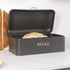 Black metal bread bin with hinged lid, labelled 'BREAD', containing a rustic loaf.