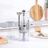 Silver hand blender set with whisk, chopper, and beaker on kitchen counter
