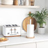 White paper towel holder with round acacia wood base, close-up view