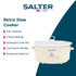 Cream Salter slow cooker on kitchen counter, cooking chilli, hand lifting glass lid