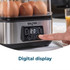 Egg boiler with digital display, poaching two eggs, hand lifting clear lid