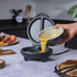 Electric omelette maker with open lid, egg mixture being poured in