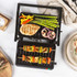 Black electric contact grill open, showing ridged plates, for sandwiches or paninis