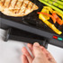 Black Salter contact grill closed, angled view, handle visible.