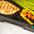 Black Salter contact grill closed, angled view, handle visible.