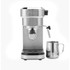 Stainless steel espresso machine with two espresso cups, milk jug and coffee grounds.