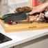Rectangular bamboo chopping board upright on kitchen worktop