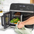 Salter air fryer oven with open door, tray of roasted vegetables being removed