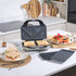 Salter 3-in-1 sandwich maker with toasted sandwiches inside, waffle and grill plates shown