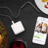 White digital kitchen scale on wooden surface with Christmas biscuits, smartphone, and hot chocolate.
