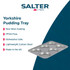 Set of non-stick oven trays and roasting tins in use for baking roast dinner and biscuits