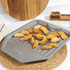 Set of non-stick roasting trays with roast chicken, vegetables and potato wedges on a kitchen worktop
