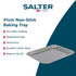 Non-stick grey bakeware set with roast chicken, vegetables, Yorkshires and cookies displayed.