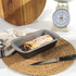 Non-stick loaf tin with a baked pastry roll on a kitchen worktop