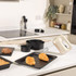 Kitchen scene with beige stand mixer and baking tins, showing croissants, tart and cakes.
