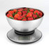 Stainless steel kitchen scale with digital display, bowl filled with fresh strawberries.
