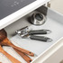Salter manual can opener with black soft-grip handles, angled view