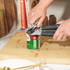 Salter manual can opener with black handles in use opening a tin on kitchen worktop
