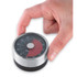Silver mechanical kitchen timer with black base, being set by hand