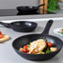 Cooked white fish fillet with grilled lemon, asparagus and spinach in frying pan