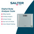 Glass bathroom scale with silver accents stored in white cabinet, sponge and toilet rolls nearby