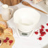White digital kitchen scale with large display and button to switch metric and imperial units