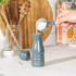 Set of two Salter salt and pepper mills in white and teal on kitchen countertop