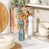 Set of two Salter salt and pepper mills in white and teal on kitchen countertop