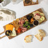 Charcuterie board with assorted cheeses, cured meats, crackers, nuts and fruit.