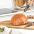 Digital food thermometer showing 83.4°C being used in cooking pot