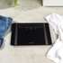Black glass digital bathroom scale with touch controls, Salter brand.