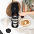 Single-serve black and silver coffee maker with travel mug, lid open
