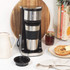 Single serve black and silver coffee maker with travel mug, side view