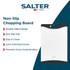 White plastic chopping board with black edges, shown upright on kitchen counter
