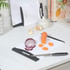 White chopping board with sliced carrot and red onion, kitchen worktop setting