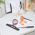 White plastic chopping board with black edge, lime cut in pieces and knife on kitchen counter