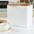 White metal bread bin with wooden lid on kitchen counter