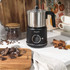 Stainless steel milk frothing jug with black plastic handle, shown empty from above.