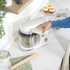 White stand mixer with stainless steel bowl, side view
