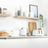 White metal bread bin and matching tea, coffee, sugar canisters, angled front view.