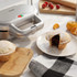 Silver Salter pie maker with fruit pies and baking ingredients on kitchen counter