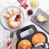 Apple and raisin pies in a pie maker, served with ice cream and custard on a marble surface
