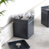 Grey metal tin containing pyramid tea bags with lid on marble worktop