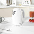 White electric kettle with chrome handle on kitchen counter